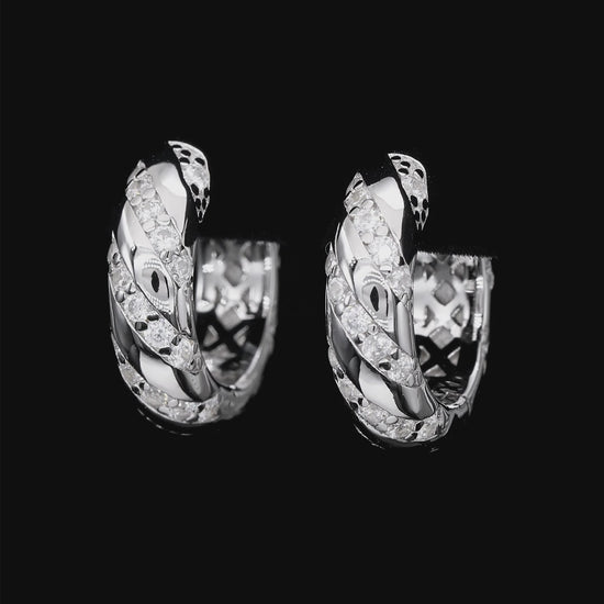 Pair of silver hoop earrings with diamond accents on a white background