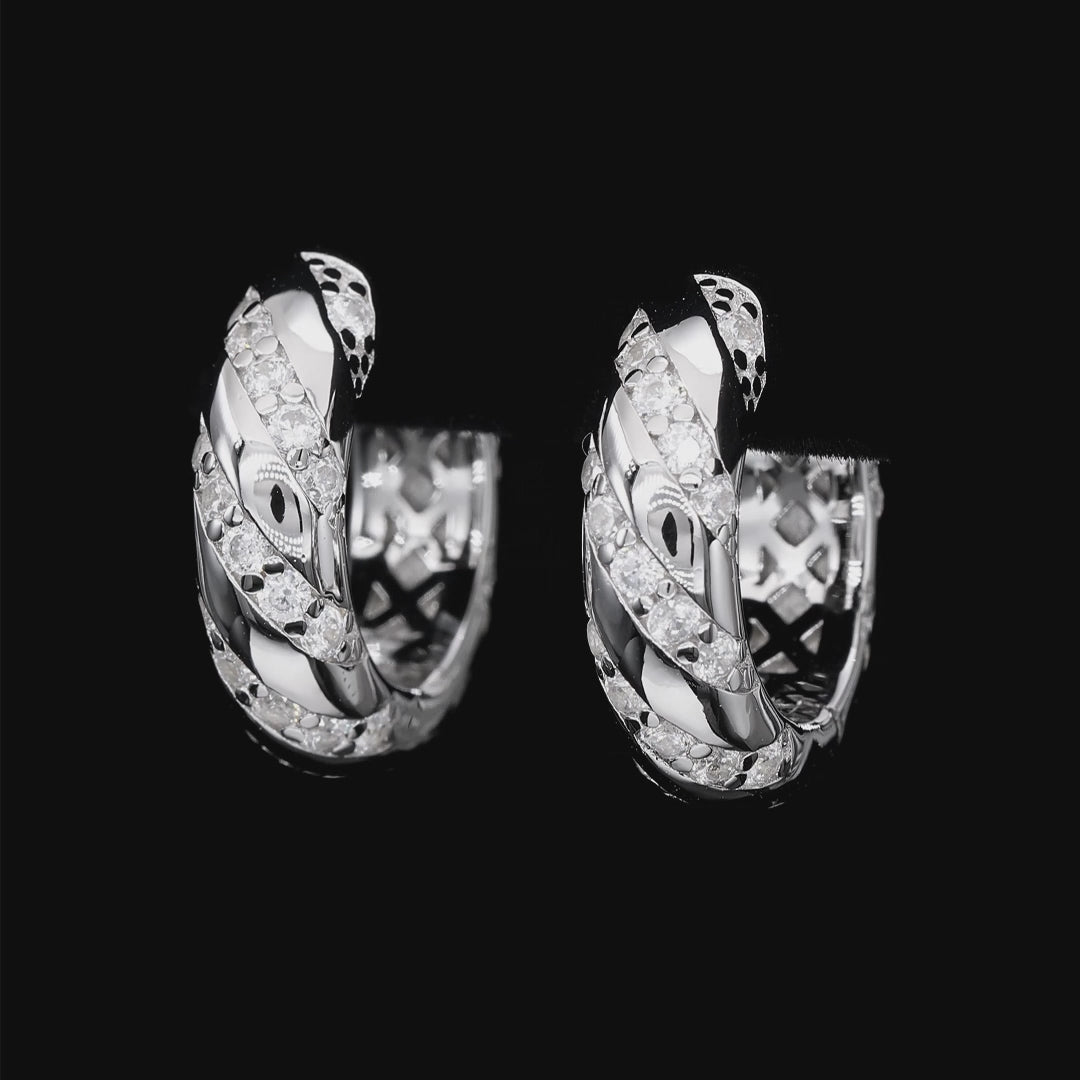 Pair of silver hoop earrings with diamond accents on a white background